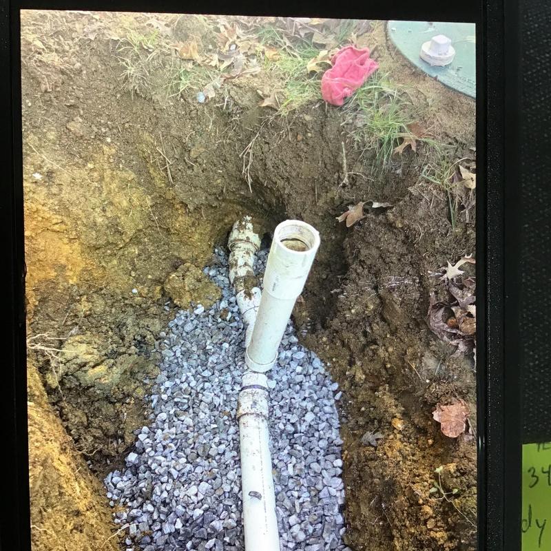 Main drain line with gravel bed in dug trench