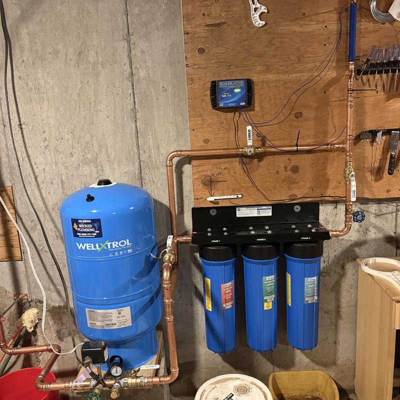 Three-stage whole house water filtration system installation