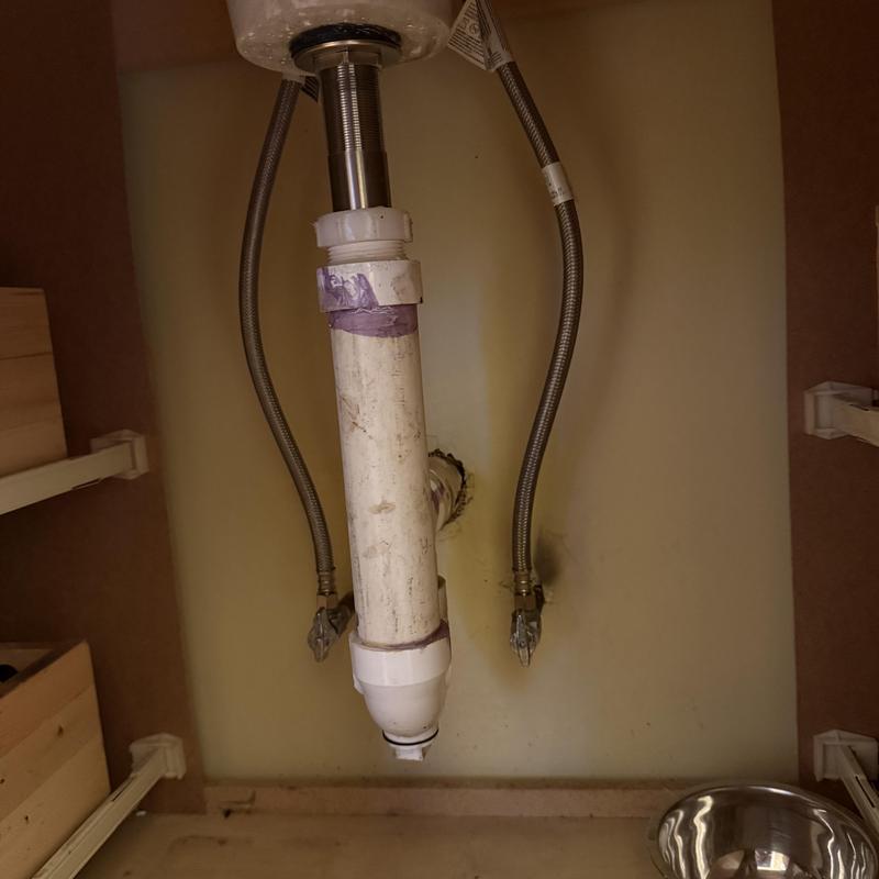 Sink drain pipe and water supply lines under sink Sink drain pipe and water supply lines under sink