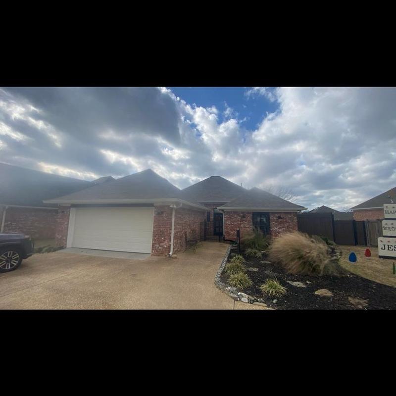 Architect shingles on residential brick house roof Architect shingles on residential brick house roof