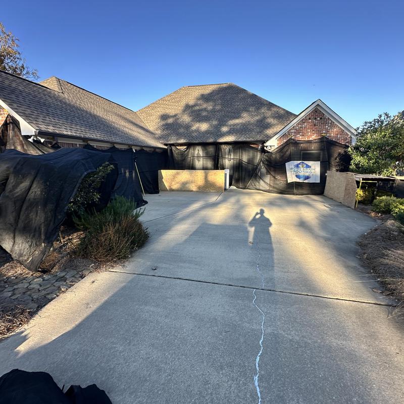 Catch All System black protective netting on house exterior