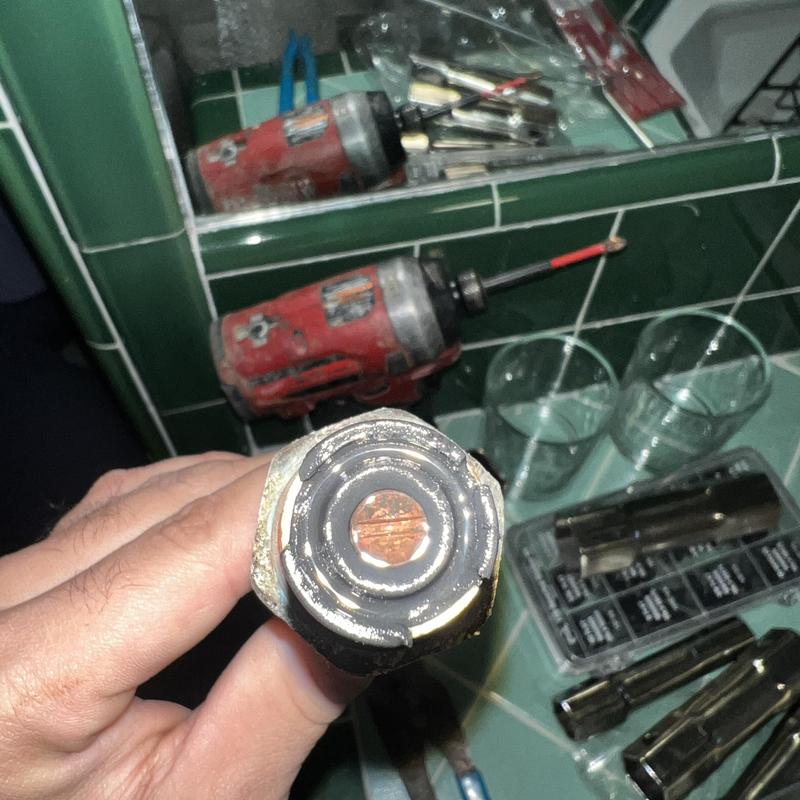 Shower stem washer close-up with tools in background