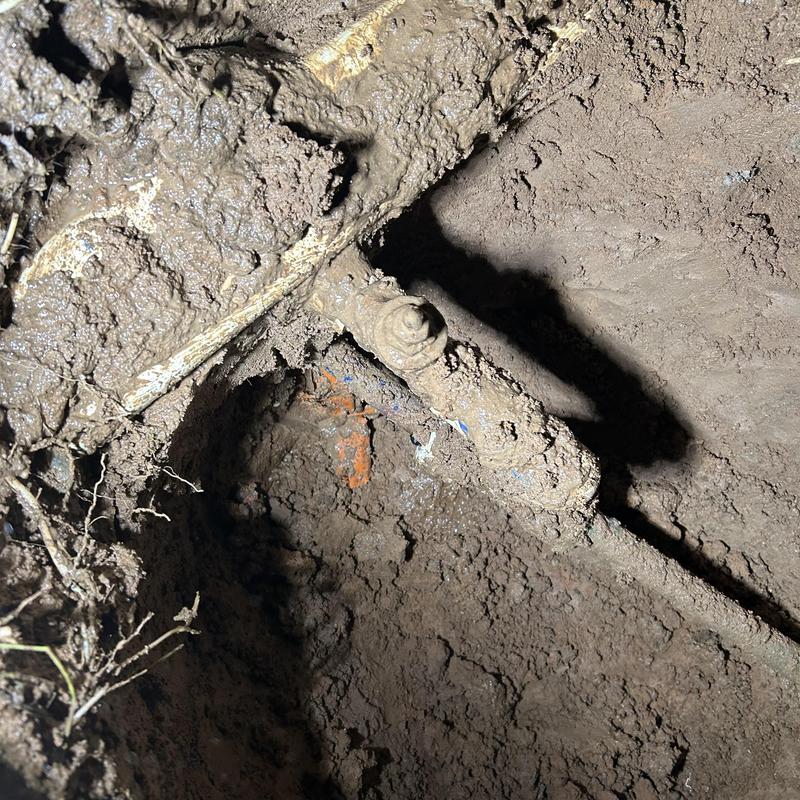 Water main pipe with new PVC fittings in soil excavation