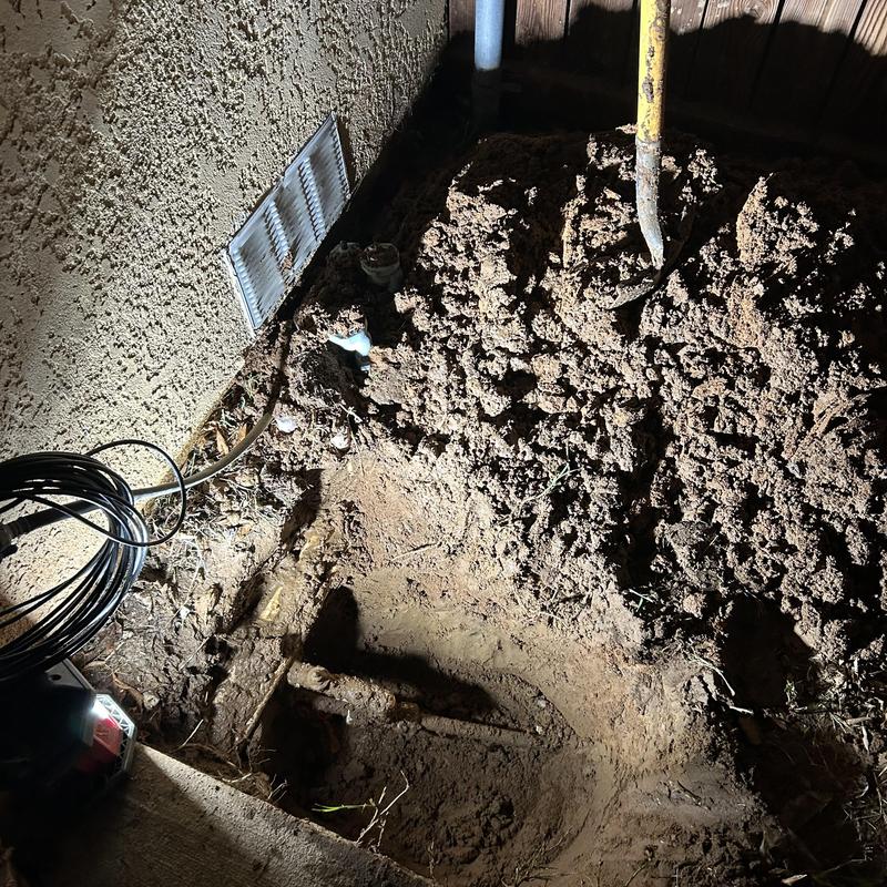 Broken PVC water main pipe excavation with shovel and soil