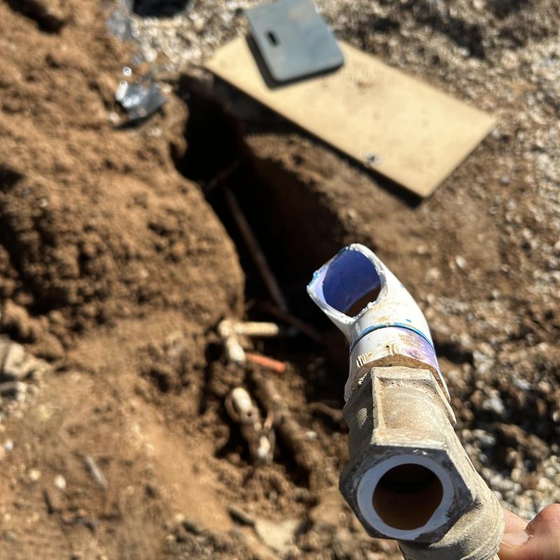 Broken water main pipe with damaged fittings outdoors