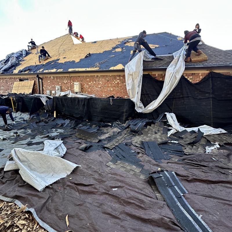 Roof shingles tear off with crew on steep roof slope