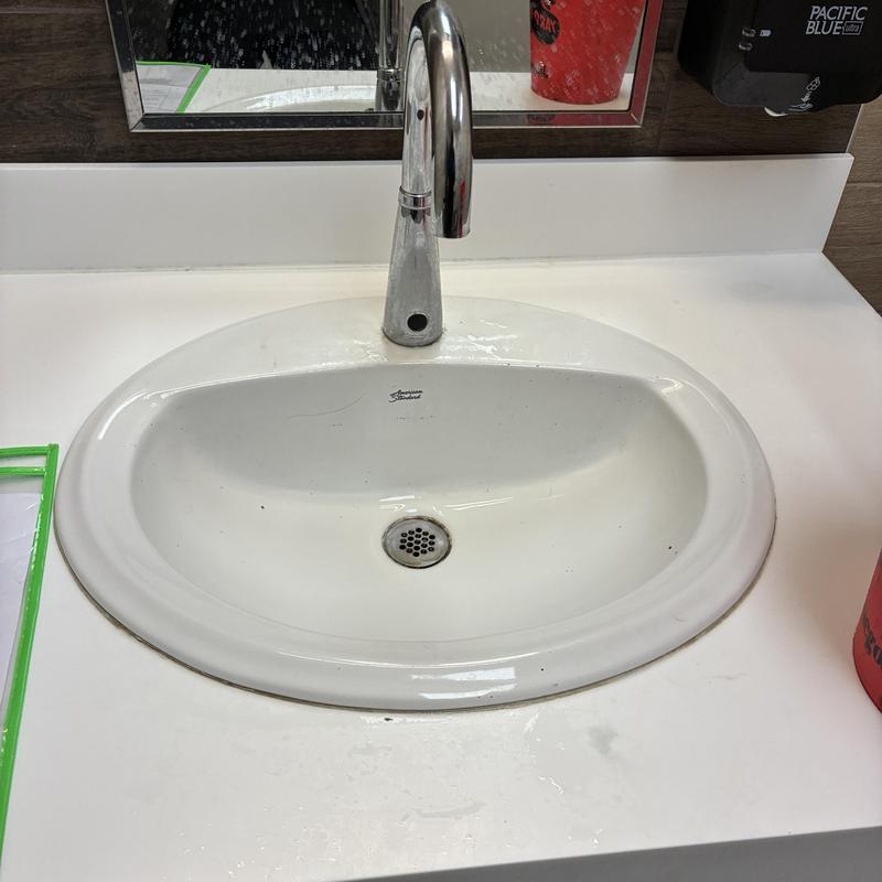 Lavatory sink drain with flowing water