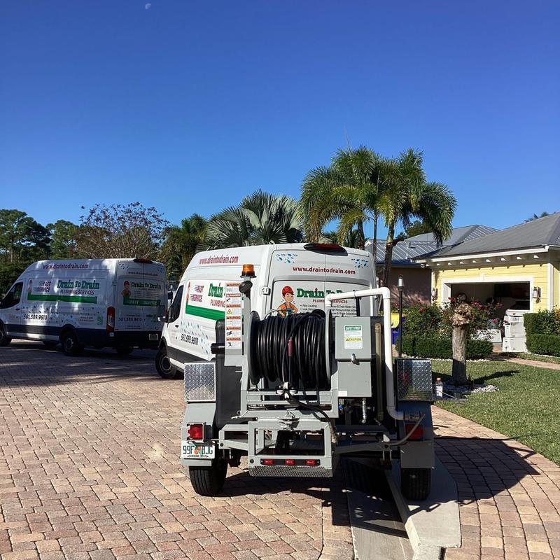 Hydro jetting equipment and plumbing service vans outdoors