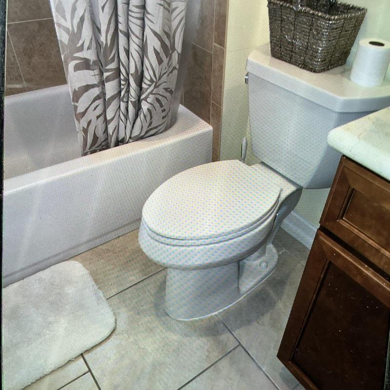 Pressure-assisted toilet installation in residential bathroom