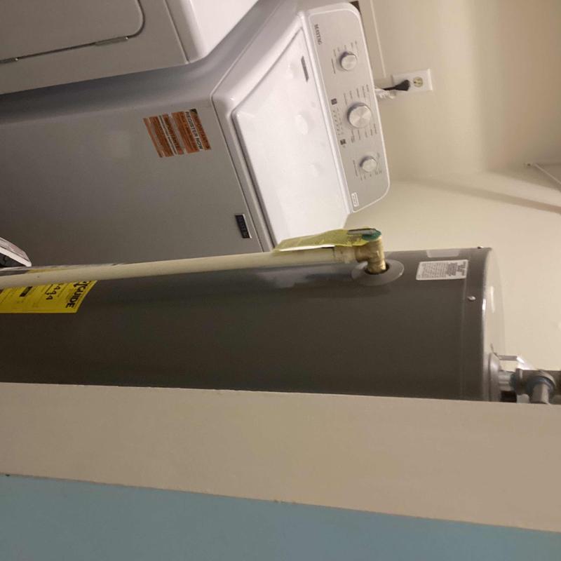 Gas water heater beside washing machine in laundry room