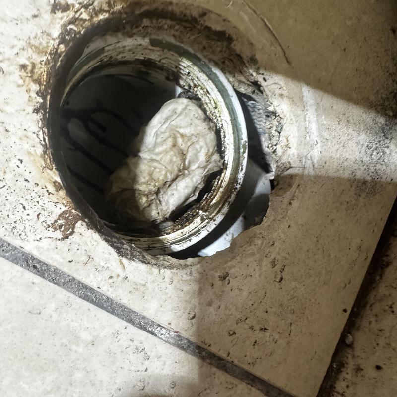 Commercial drain pipe blockage with debris buildup