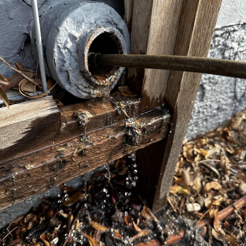 Main sewer line blockage with water leak and cleaning rod
