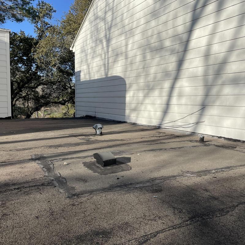 Modified bitumen flat roof with vents and wall shadow