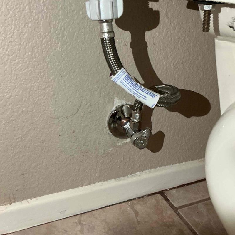 Angle stop valve and supply line under toilet tank