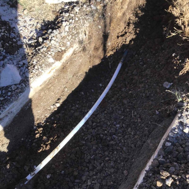 Waterline pipe trench with exposed soil and gravel
