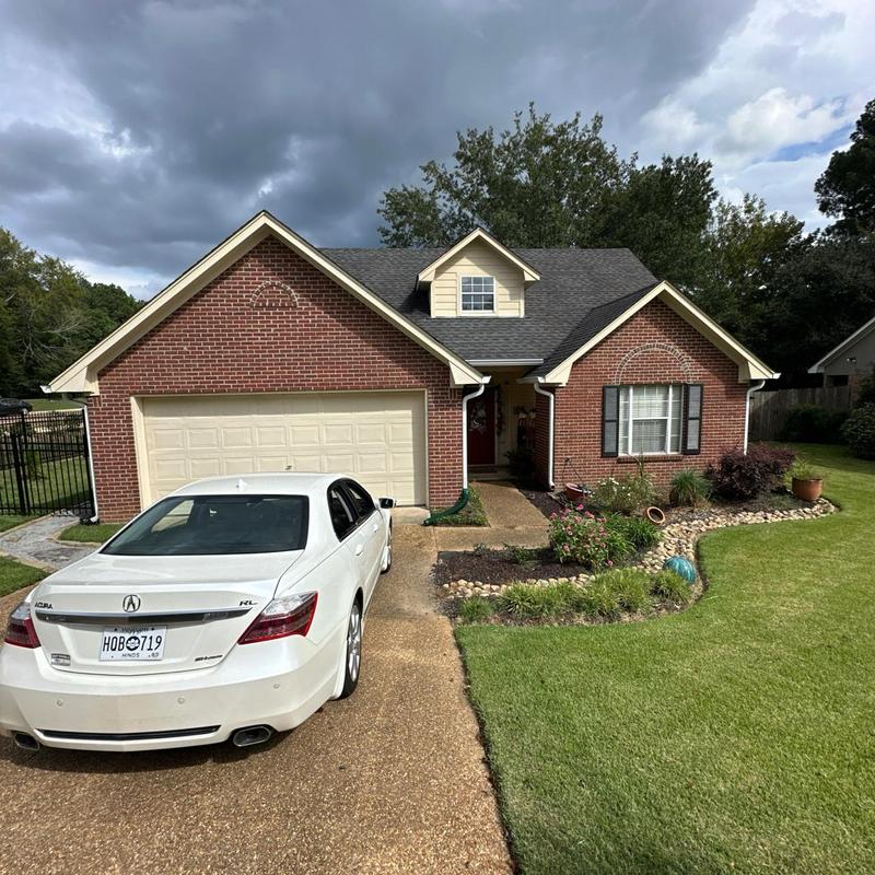 Asphalt shingle roof with brick house and driveway