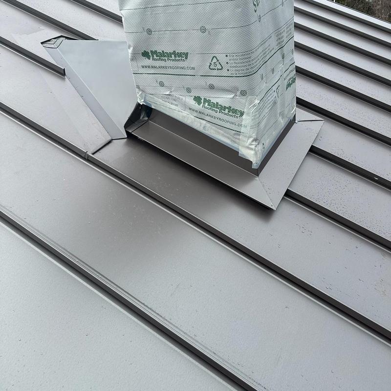 Standing seam steel roof with chimney flashing Standing seam steel roof with chimney flashing