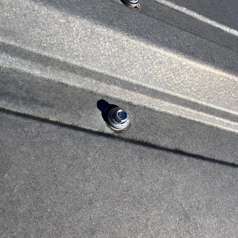 Metal roof panels with fasteners and sealants