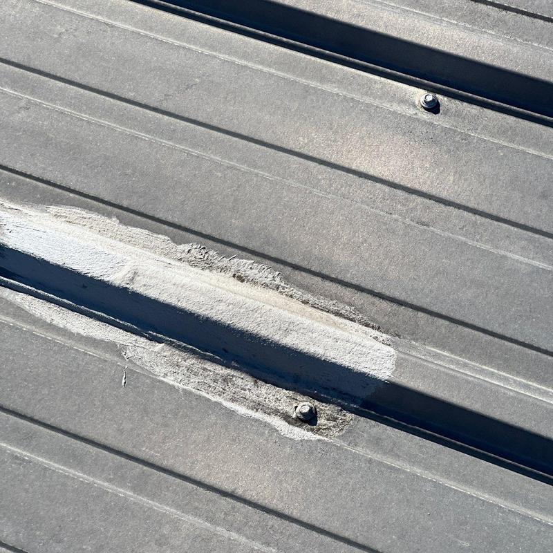 Metal roof seam with rust and patch coating