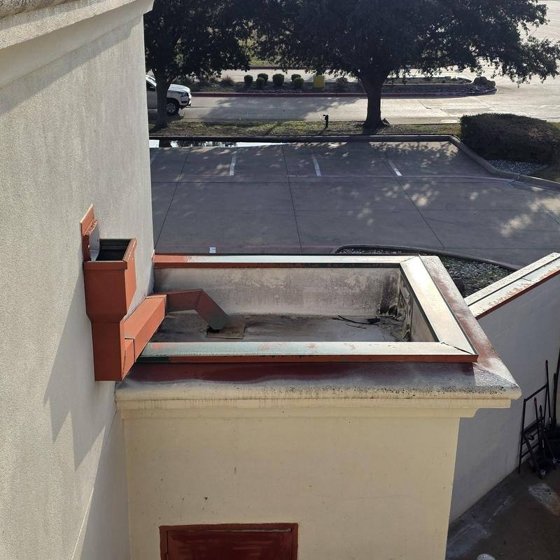 Roof drainage scupper and curb with rust and debris Roof drainage scupper and curb with rust and debris