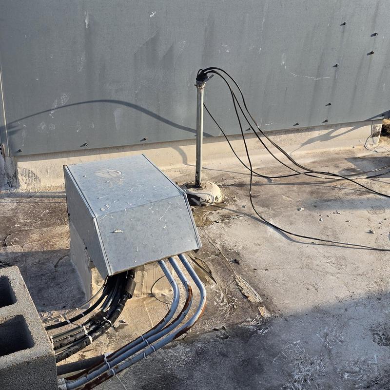 Roof electrical conduit with cable leaks and damaged sealant Roof electrical conduit with cable leaks and damaged sealant