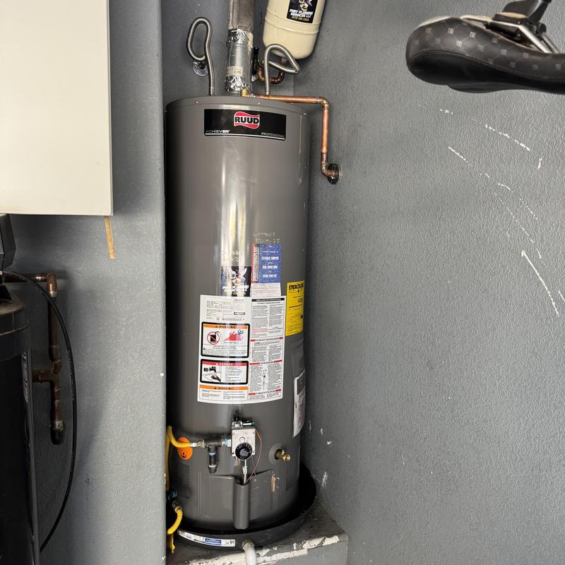 Gas water heater with copper piping in utility room