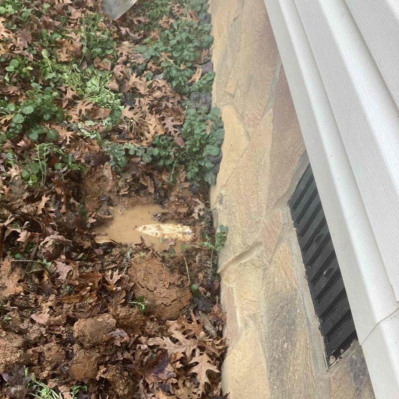 Main water line dug up and exposed near foundation wall