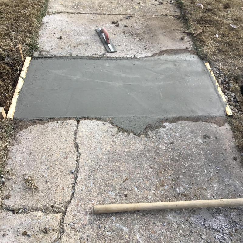 Concrete sidewalk patch over water line repair