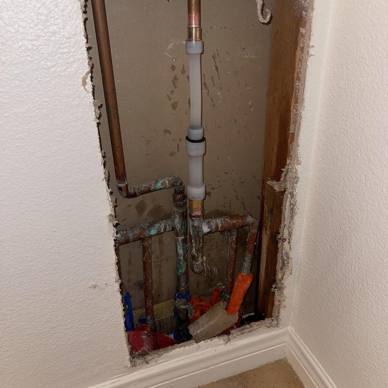 Copper water line with PEX repair in wall cavity