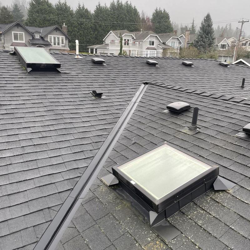 Roof skylights with flashing on shingle roof