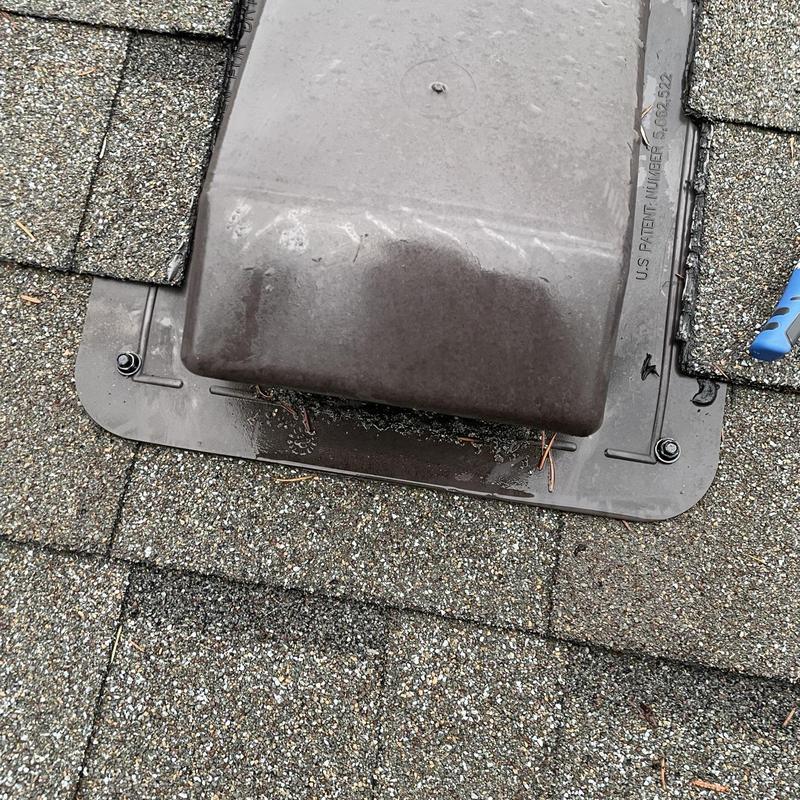 Roof exhaust vent with secured fasteners on shingles