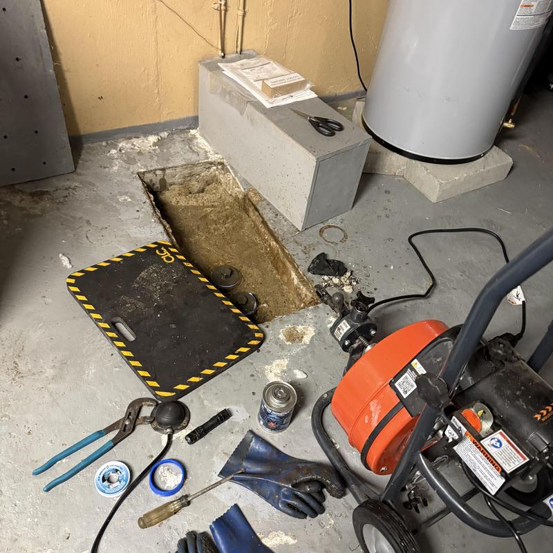 Main drain cleaning equipment and opened drain in basement