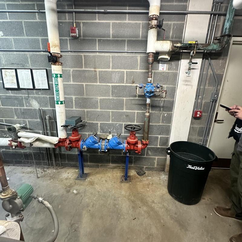 Backflow prevention assembly with blue valves and piping