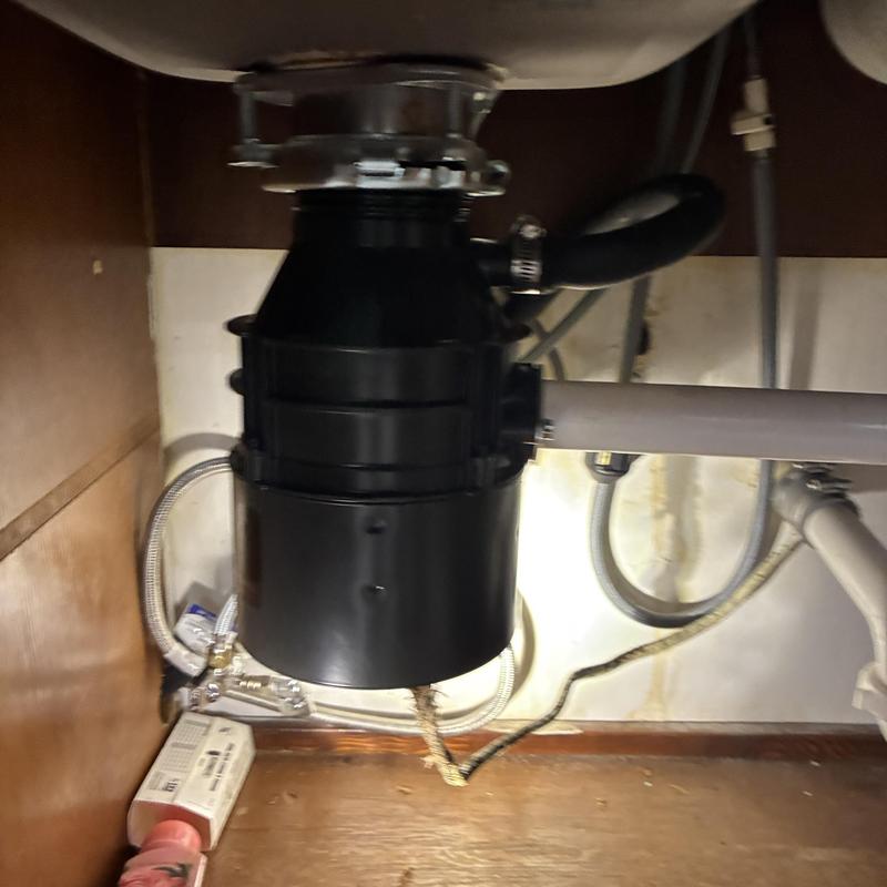 Garbage disposal unit installed under kitchen sink