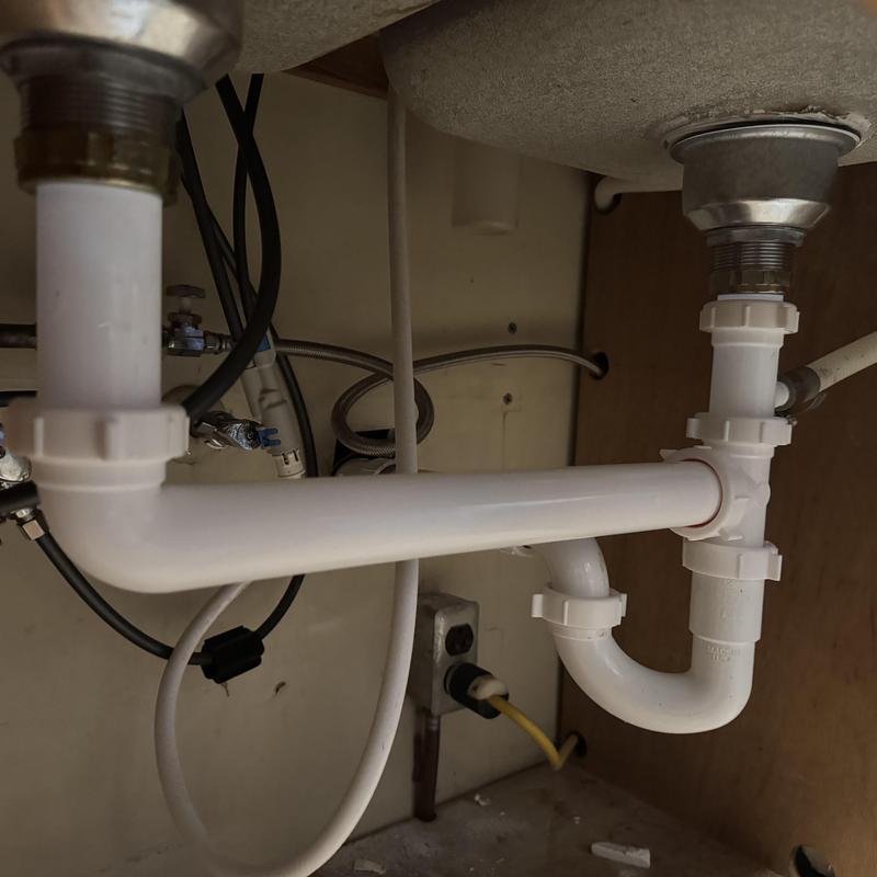 PVC double sink drain pipes under cabinet