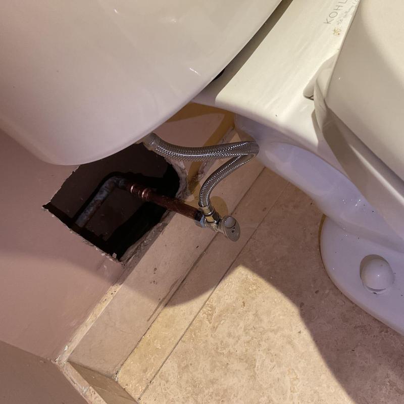 Toilet supply line and angle stop installation near wall hole