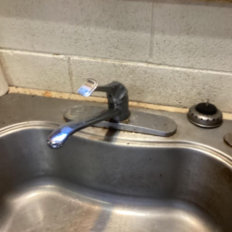 Kitchen sink faucet on stainless steel sink