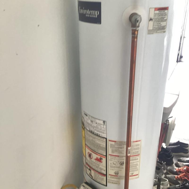 Water heater with copper piping installation in corner
