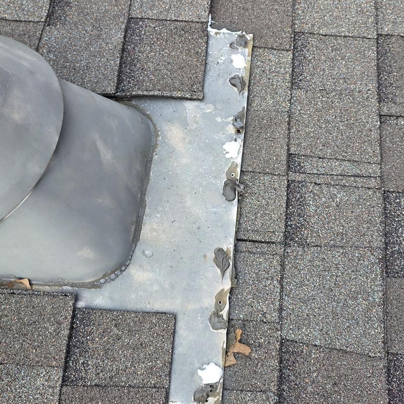 Roof vent flashing with hail damage on shingles