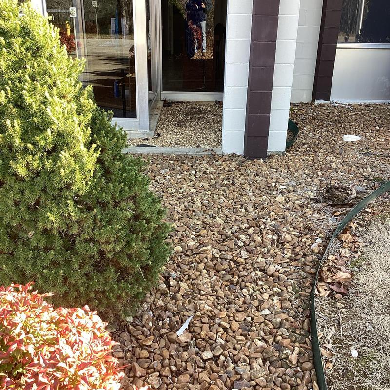 Building main sewer line cleanout outside entrance with gravel