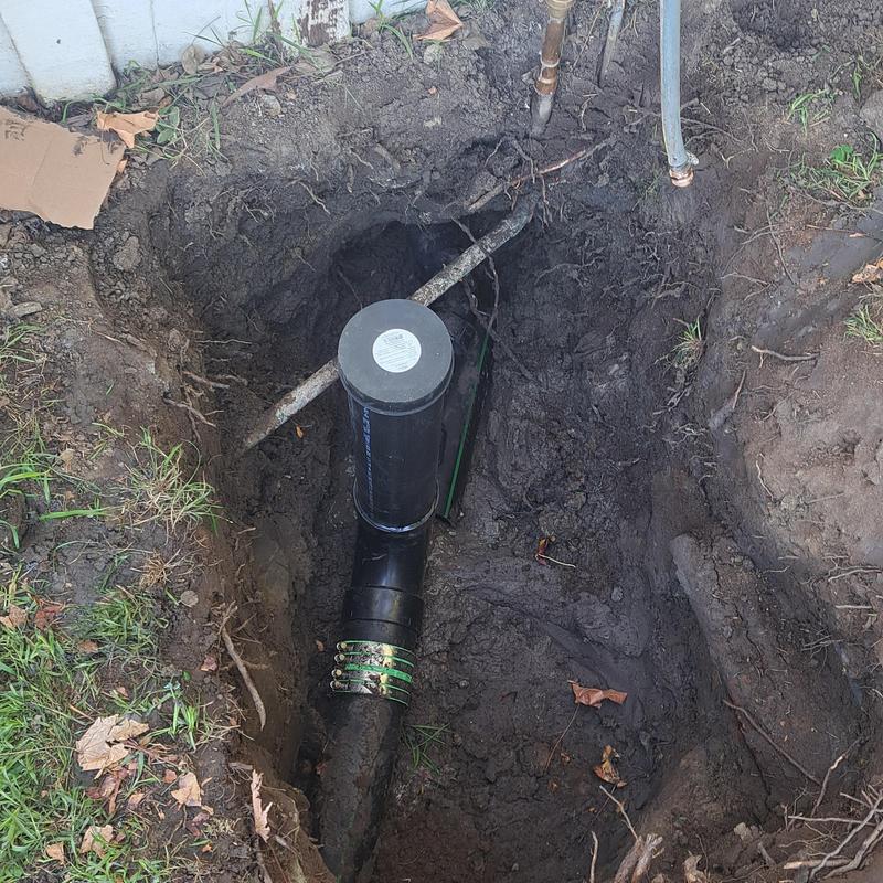 Sewer line with cleanout access in dug trench Sewer line with cleanout access in dug trench