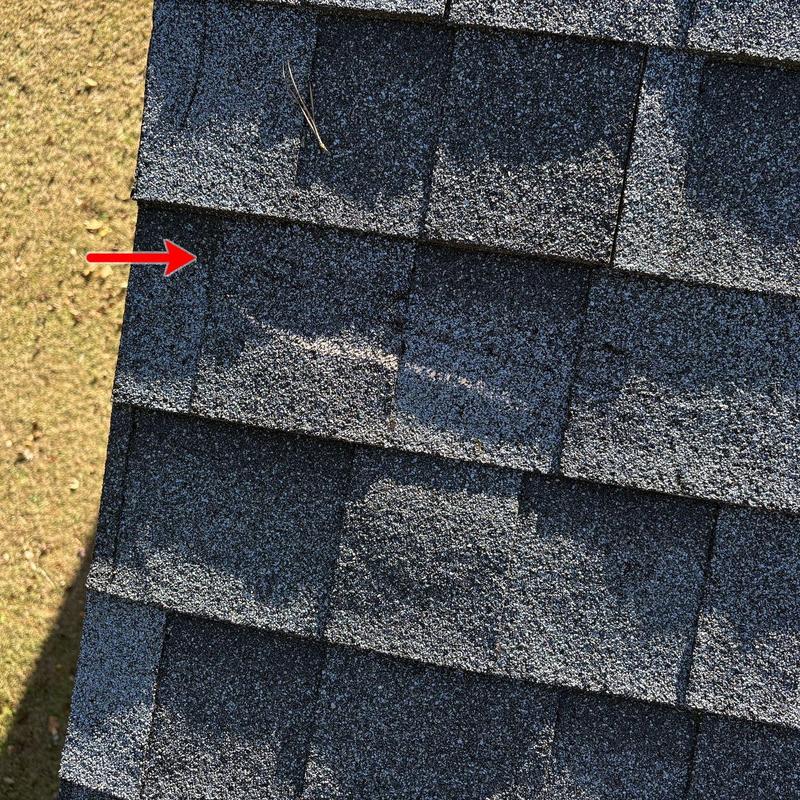 Asphalt roof shingles with wind and hail damage marked