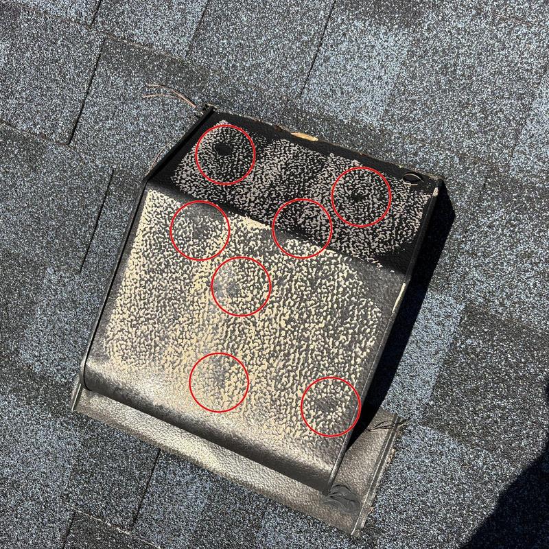 Roof vent with hail impact damage circled in red