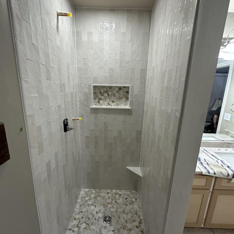 Custom tile shower unit with pebble floor and niche Custom tile shower unit with pebble floor and niche