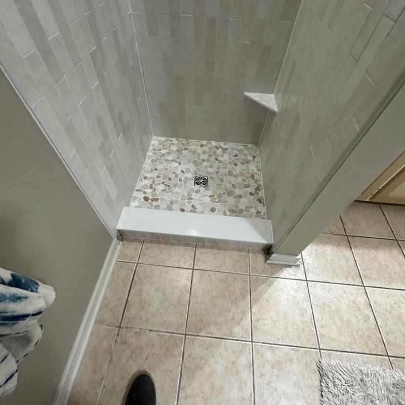 Custom tile shower base with corner shelf installation Custom tile shower base with corner shelf installation