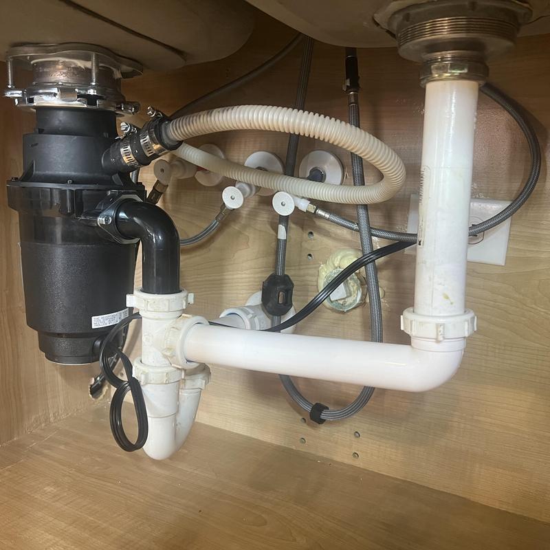 Half horse garbage disposal with plumbing under sink
