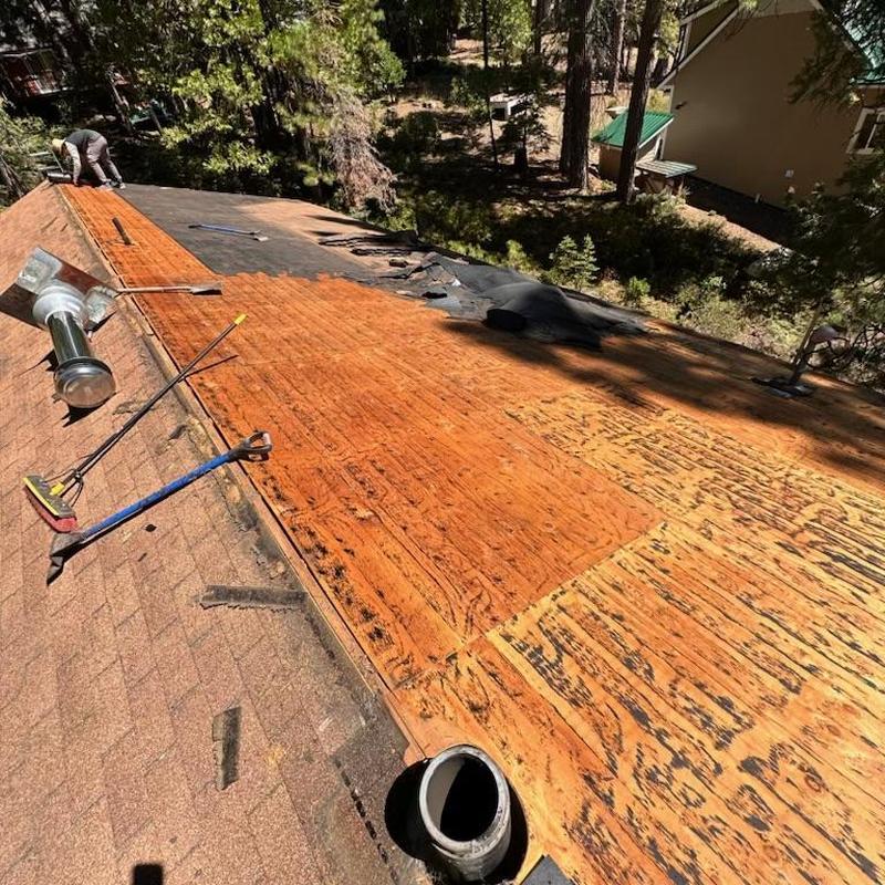 Roof decking replacement on asphalt shingle roof in progress
