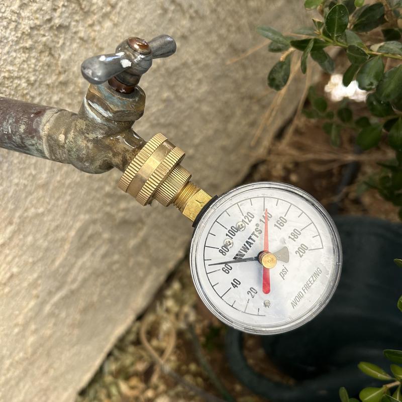 Water pressure gauge on outdoor faucet reading 110 psi