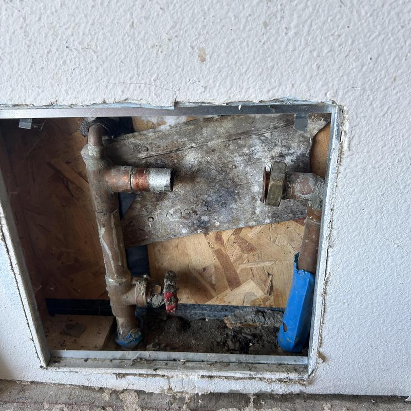 Copper water pipes with valve and fittings in wall cavity