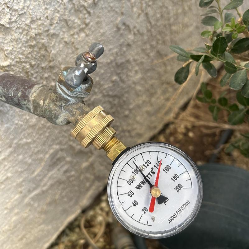 Water pressure gauge on outdoor spigot at 110 psi
